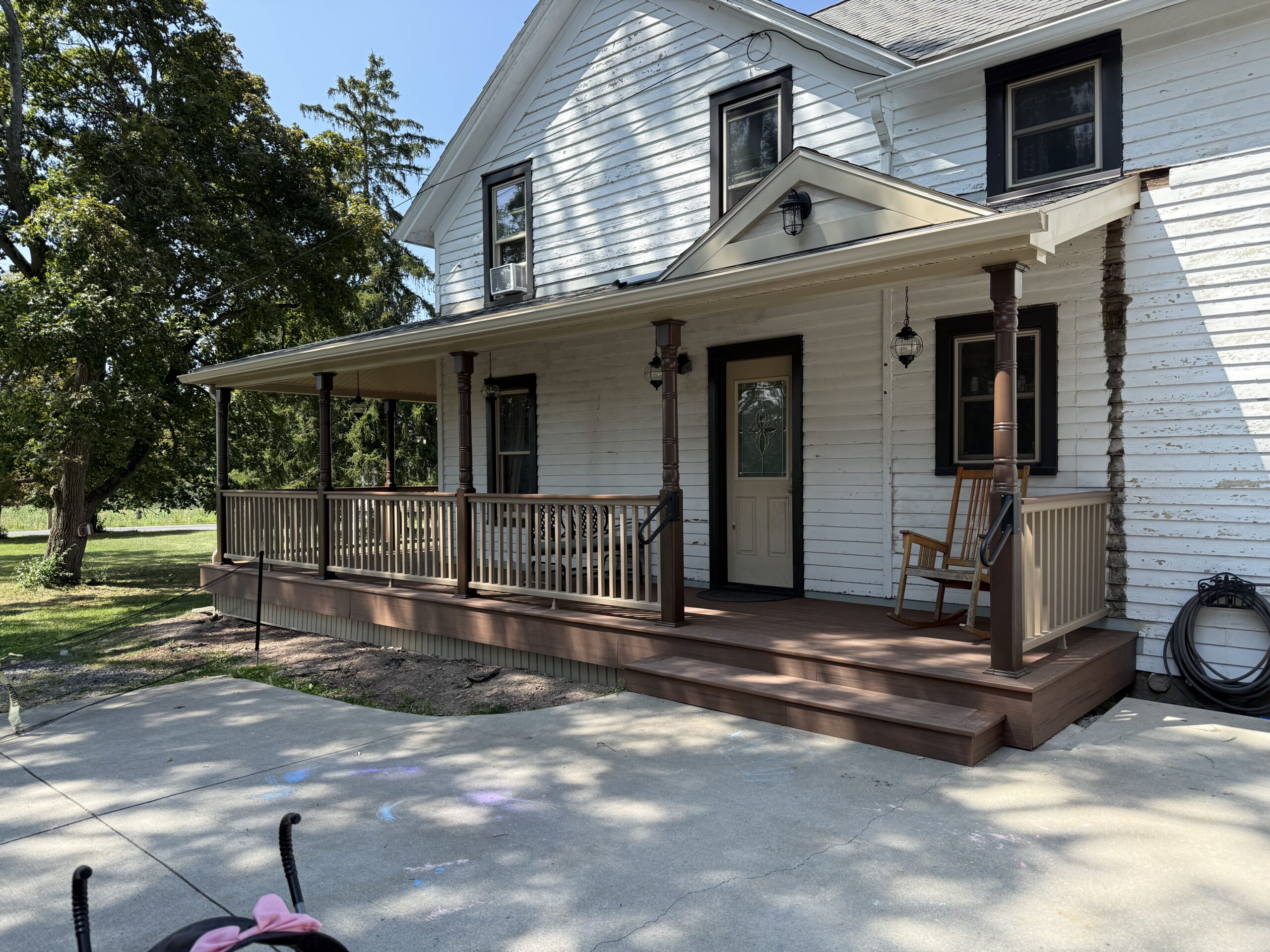 100-year-old historic farmhouse wrap-around porch using TimberTech decking in Fleming, NY by WeBuild CNY