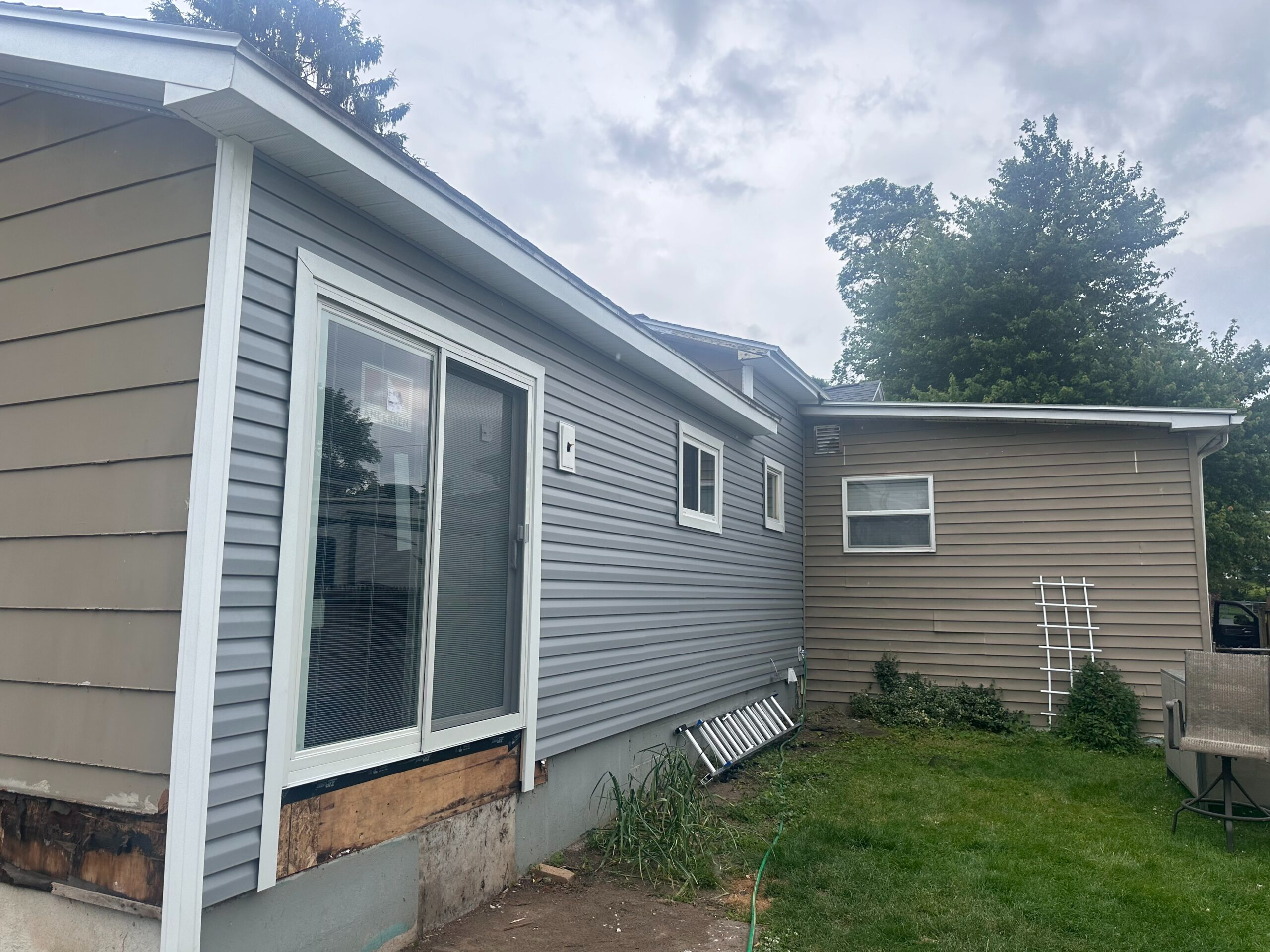 After photo of beautiful new vinyl siding installed on a home in Auburn, New York, prepared for a future custom deck addition