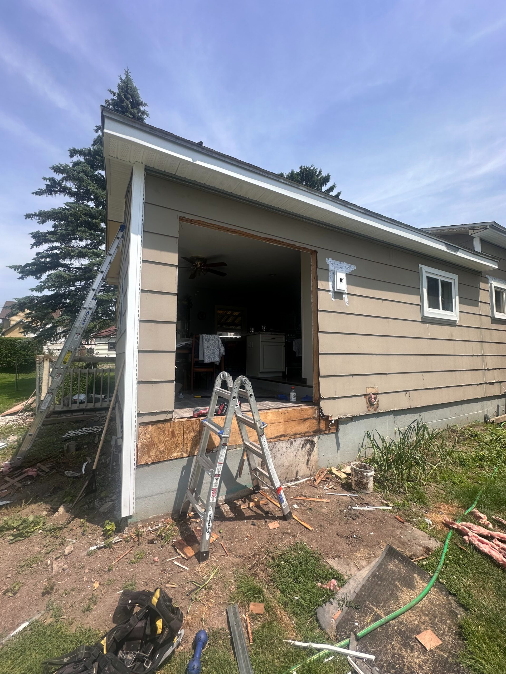 Before photo of a residential home in Auburn, NY awaiting premium vinyl siding installation and a future custom deck by WeBuild CNY