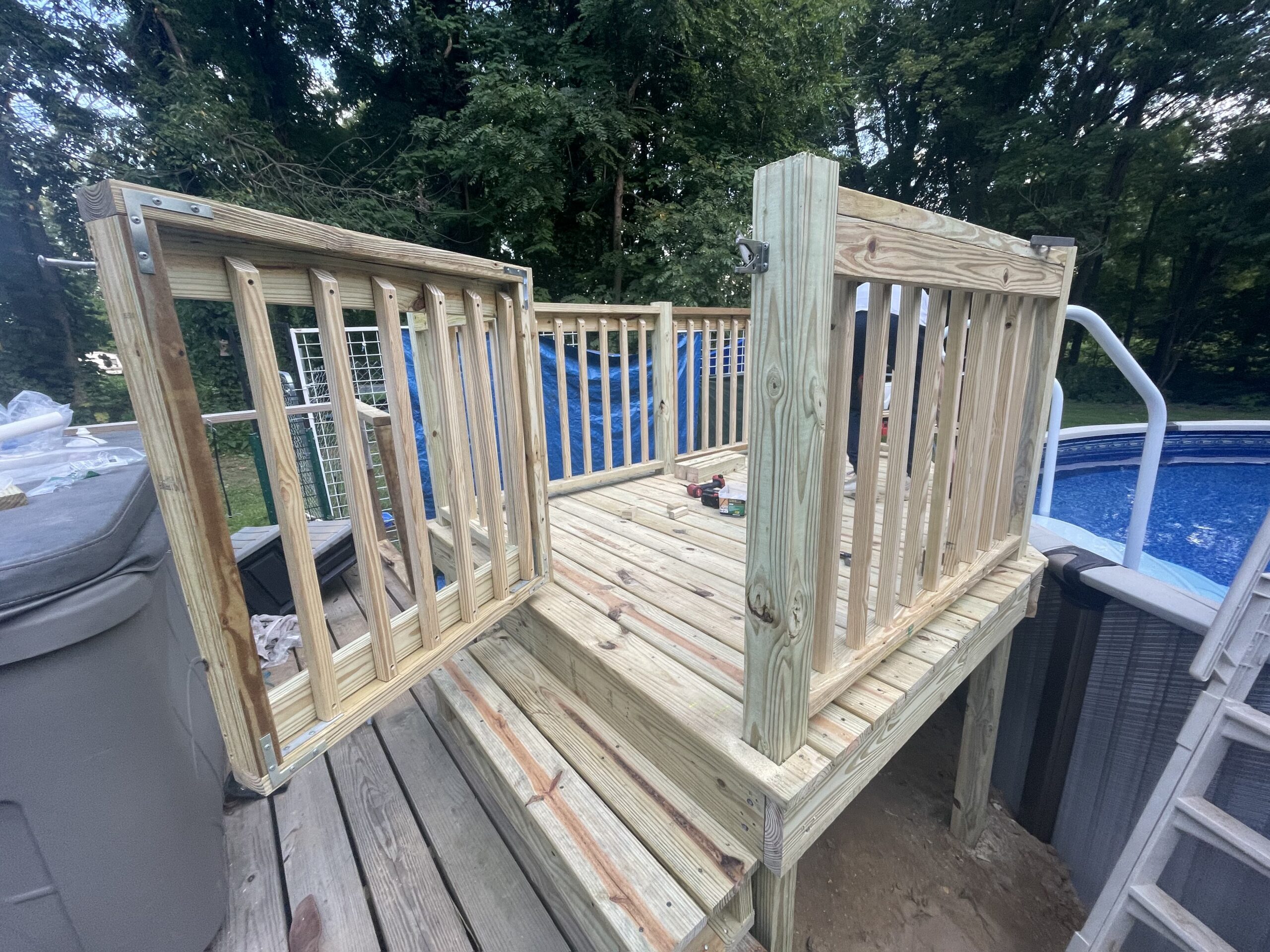 Beautiful custom wood pool deck and safety stairs built by WeBuild CNY in Auburn, New York