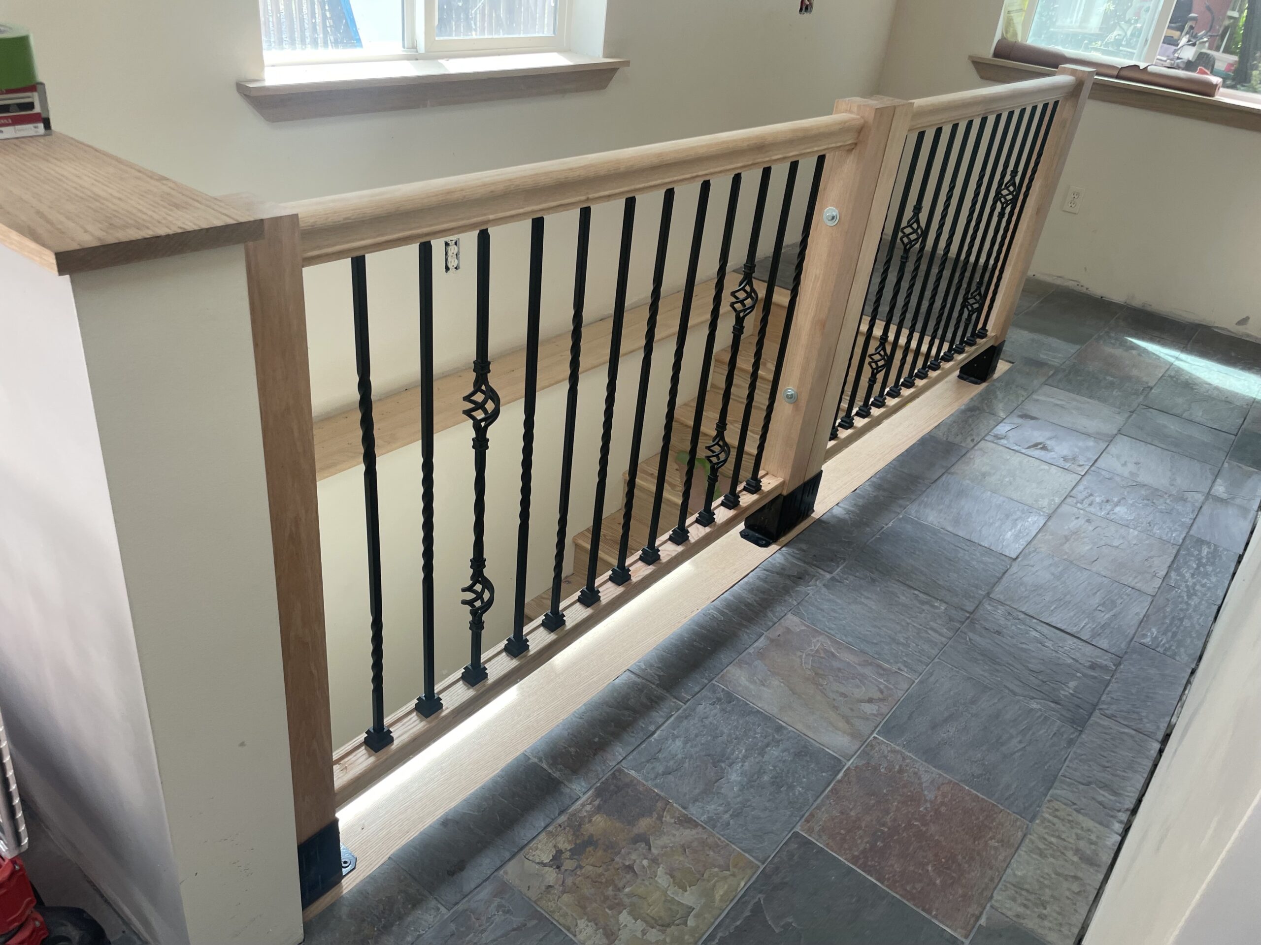 Custom hardwood stair railing and elegant baluster installation in a residential Auburn, NY home by WeBuild CNY