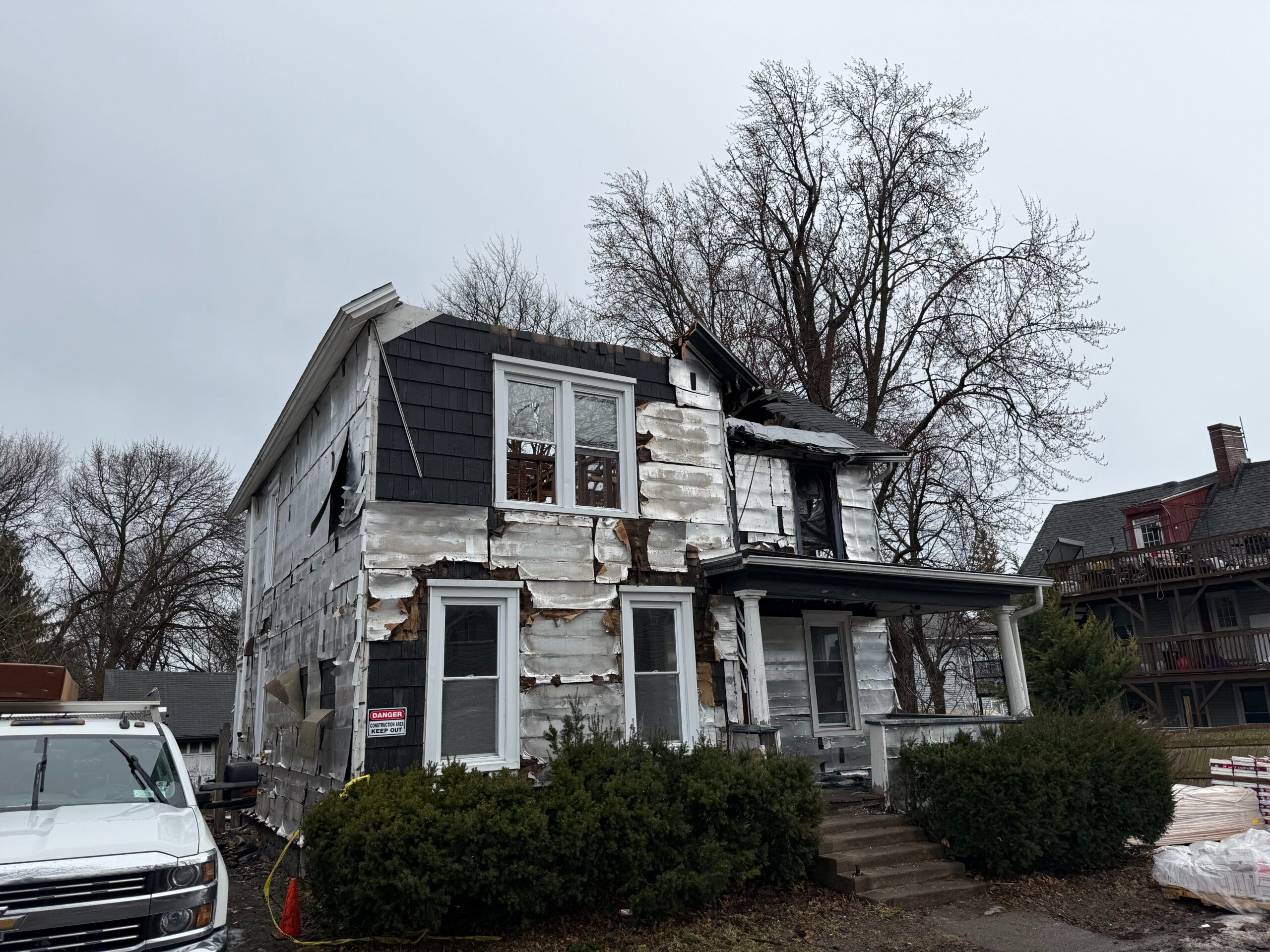 Before photo showing severe attic fire and structural damage to a residential home in Auburn, NY prior to restoration by WeBuild CNY