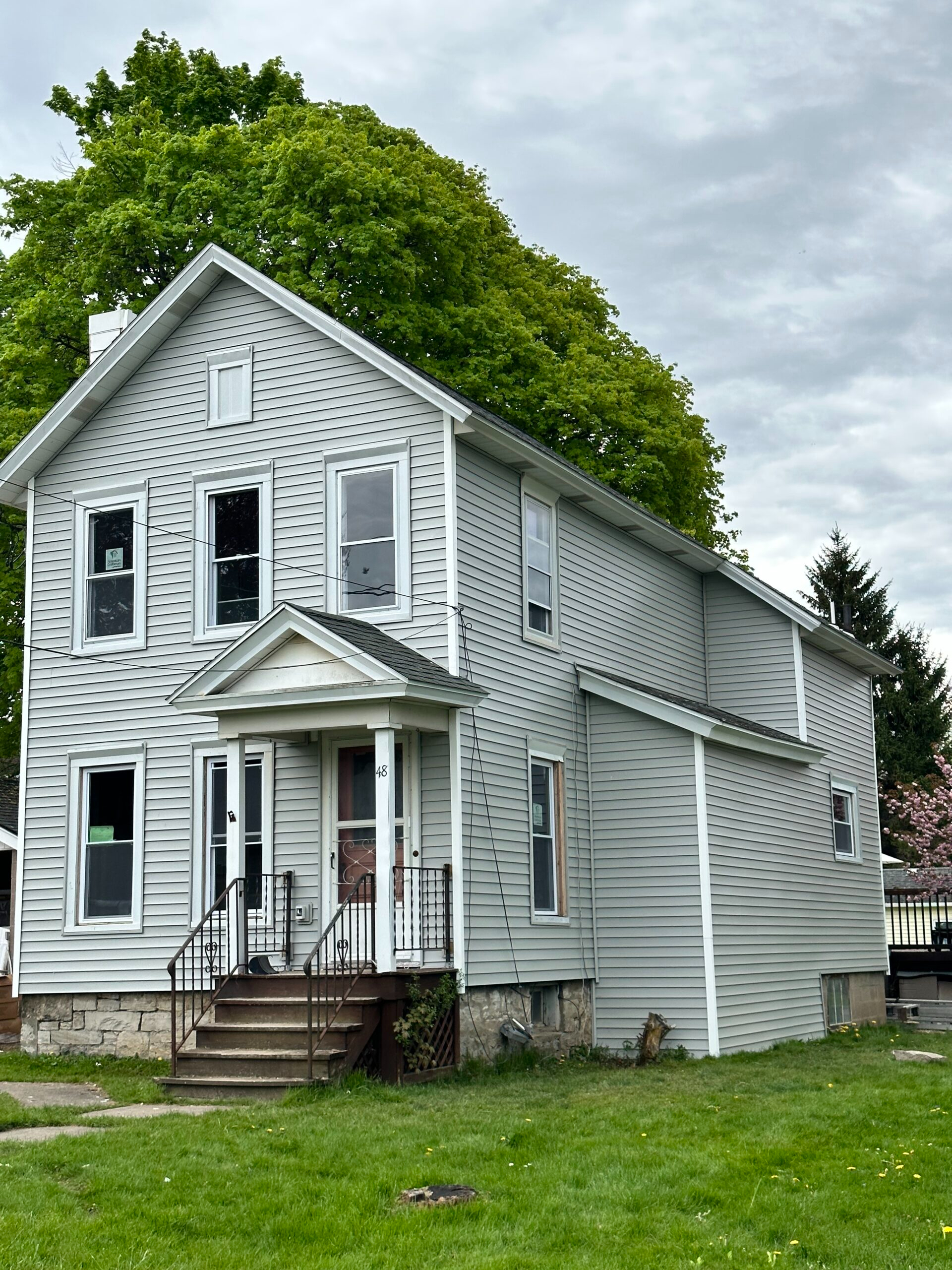 After photo of a complete exterior remodel featuring premium vinyl siding on a two-story home in Auburn, Cayuga County, New York