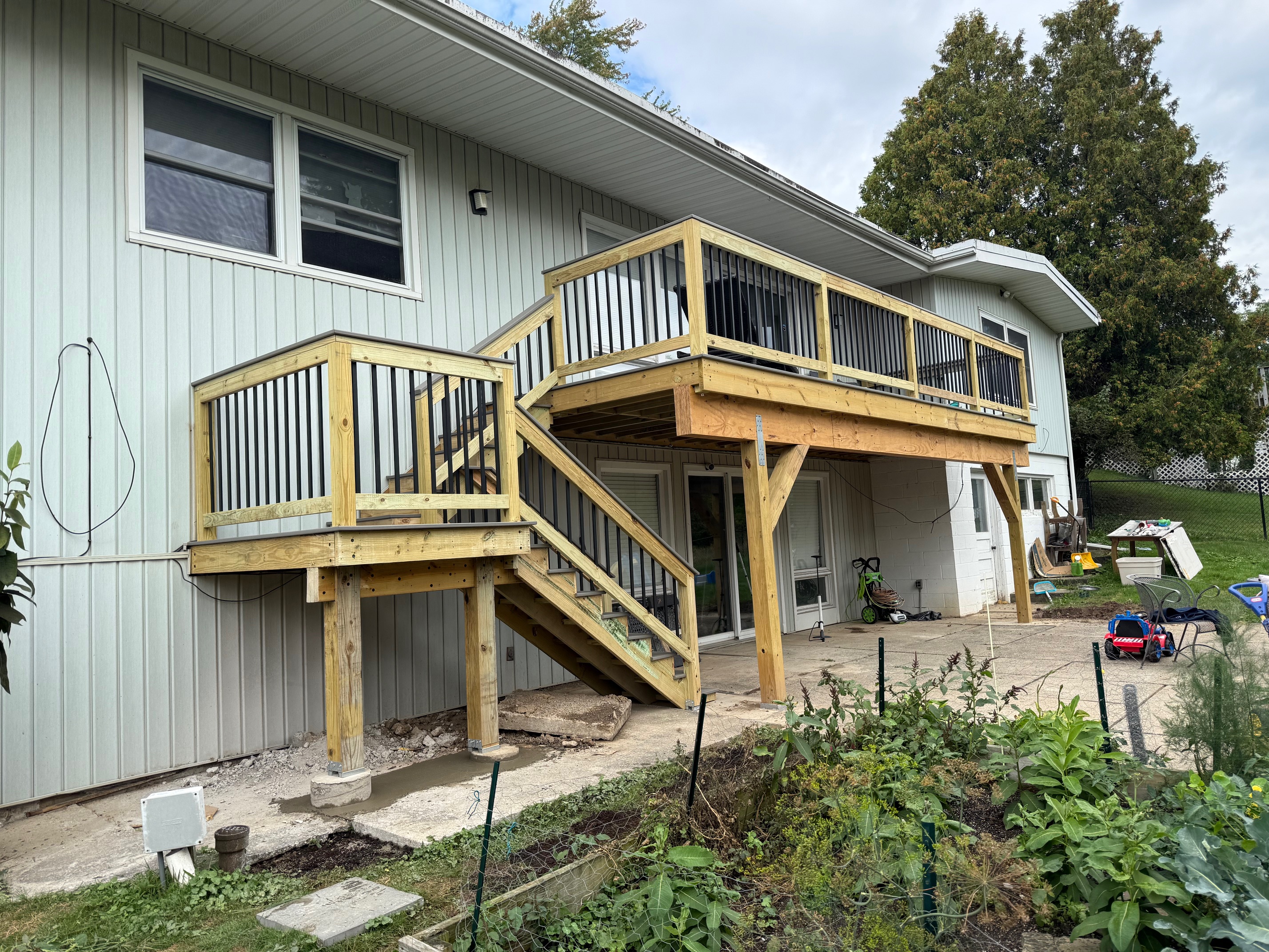 Expansive 24-foot TimberTech composite deck in Sea Salt Grey built by WeBuild CNY over a walkout basement in Owasco, New York