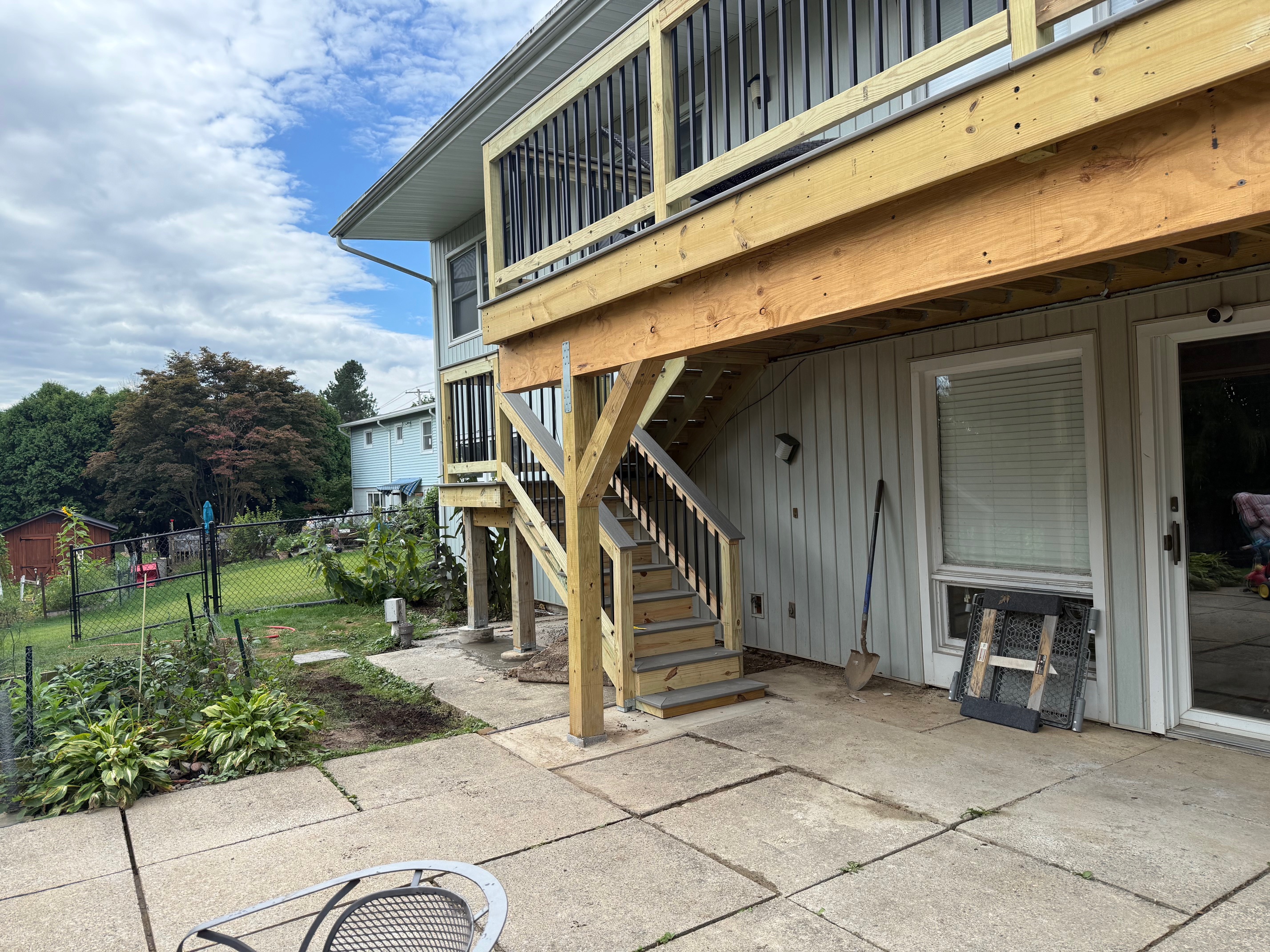 Detail view of structural deck framing using Versa-Lam LVL beams to minimize support posts over a walkout basement patio in Cayuga County
