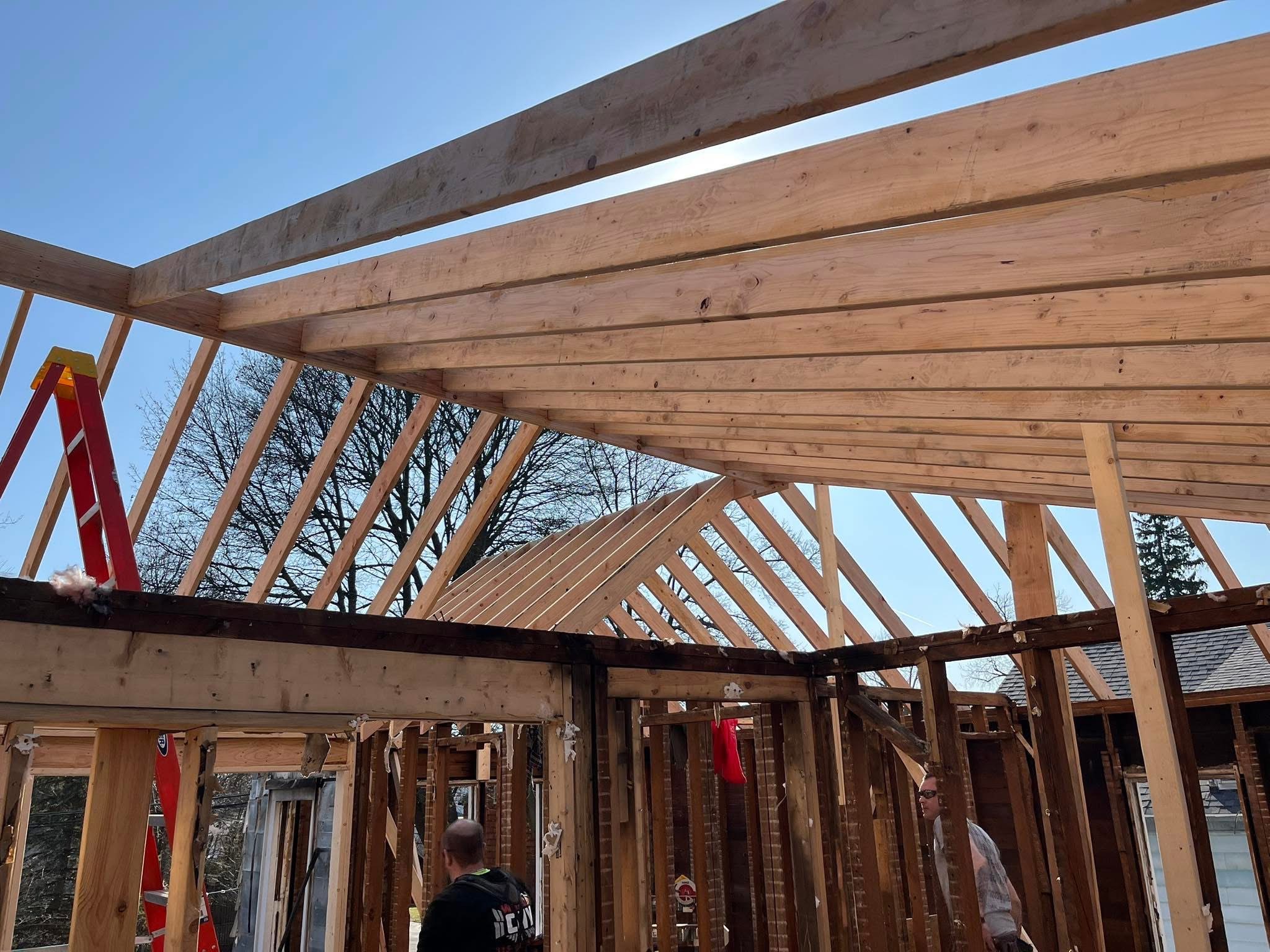 Installing new roof trusses and structural supports to restore a fire-damaged residential property