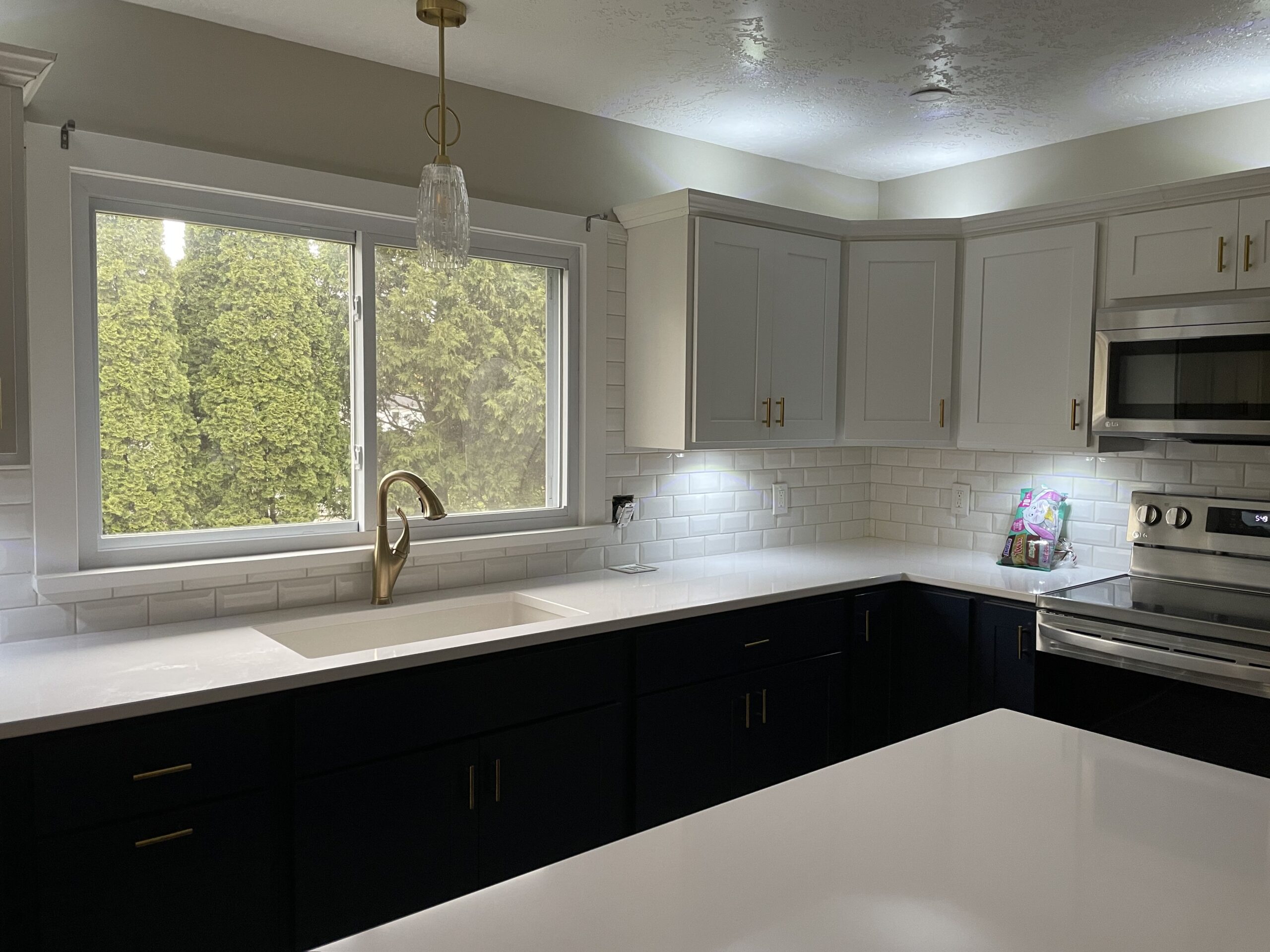 Modern kitchen renovation featuring custom cabinetry and a spacious central island