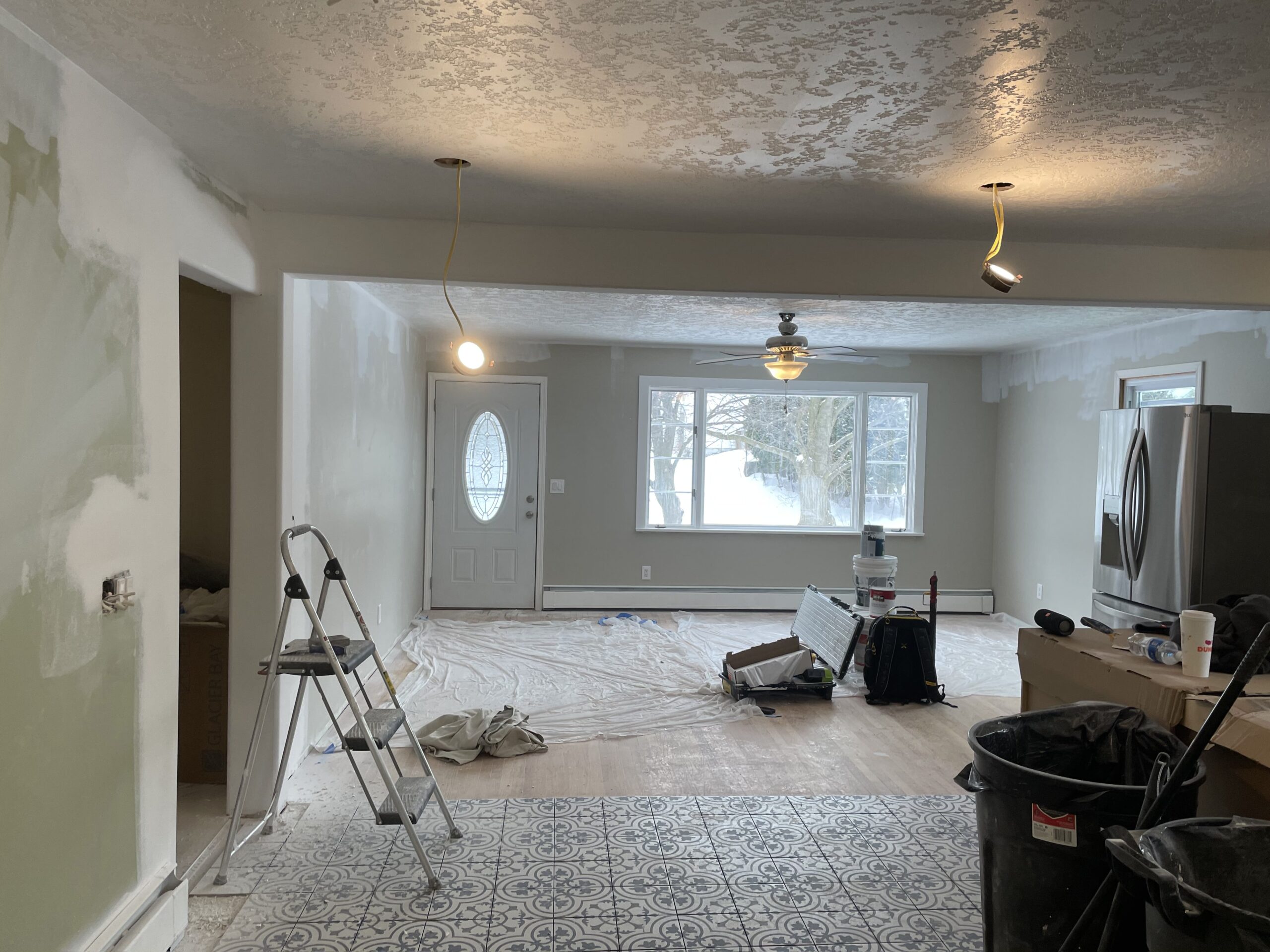 Drywall installation, electrical upgrades, and kitchen layout planning during a home remodel
