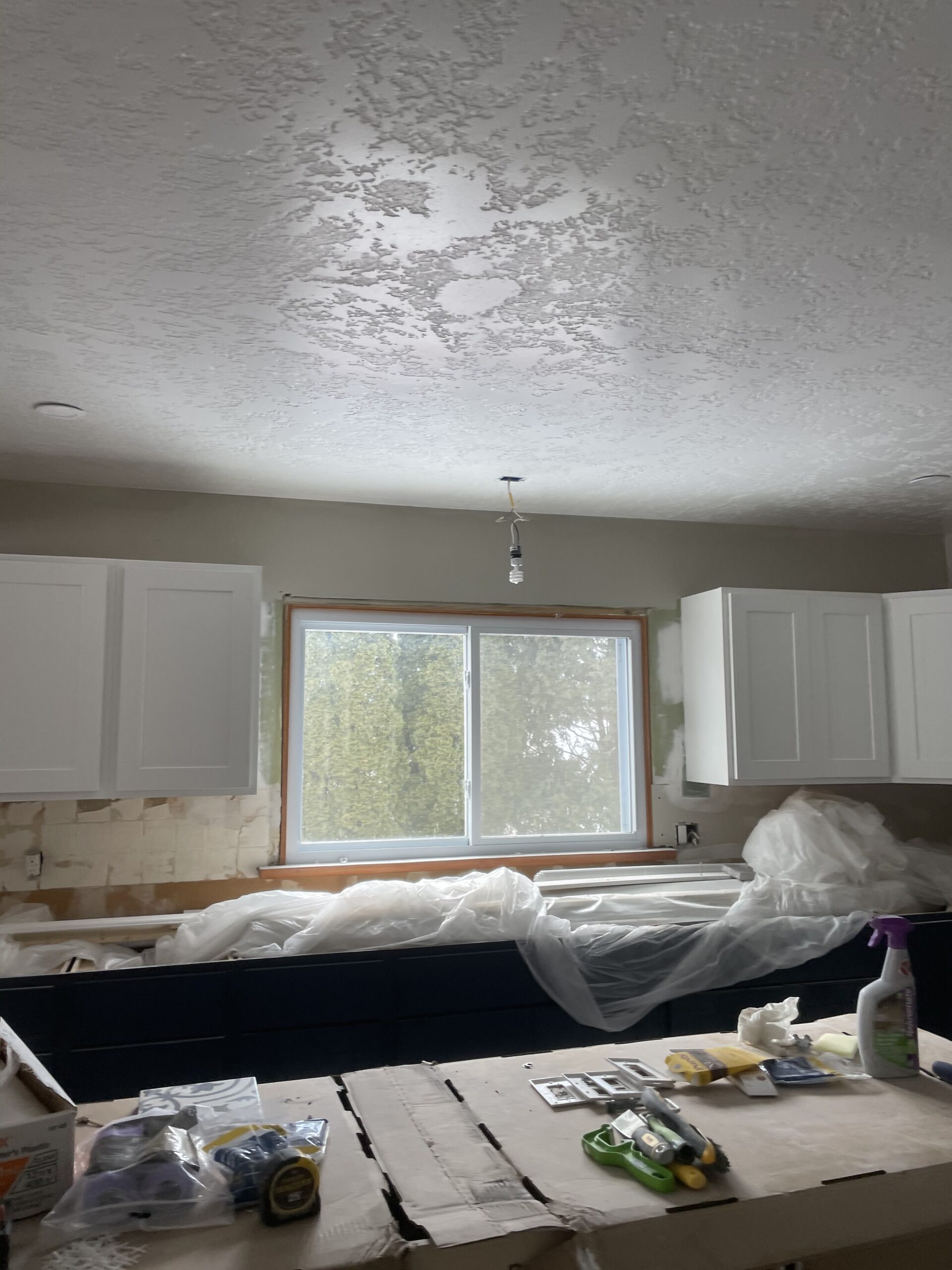 WeBuild CNY remodeling contractors installing custom kitchen cabinets and preparing for flooring