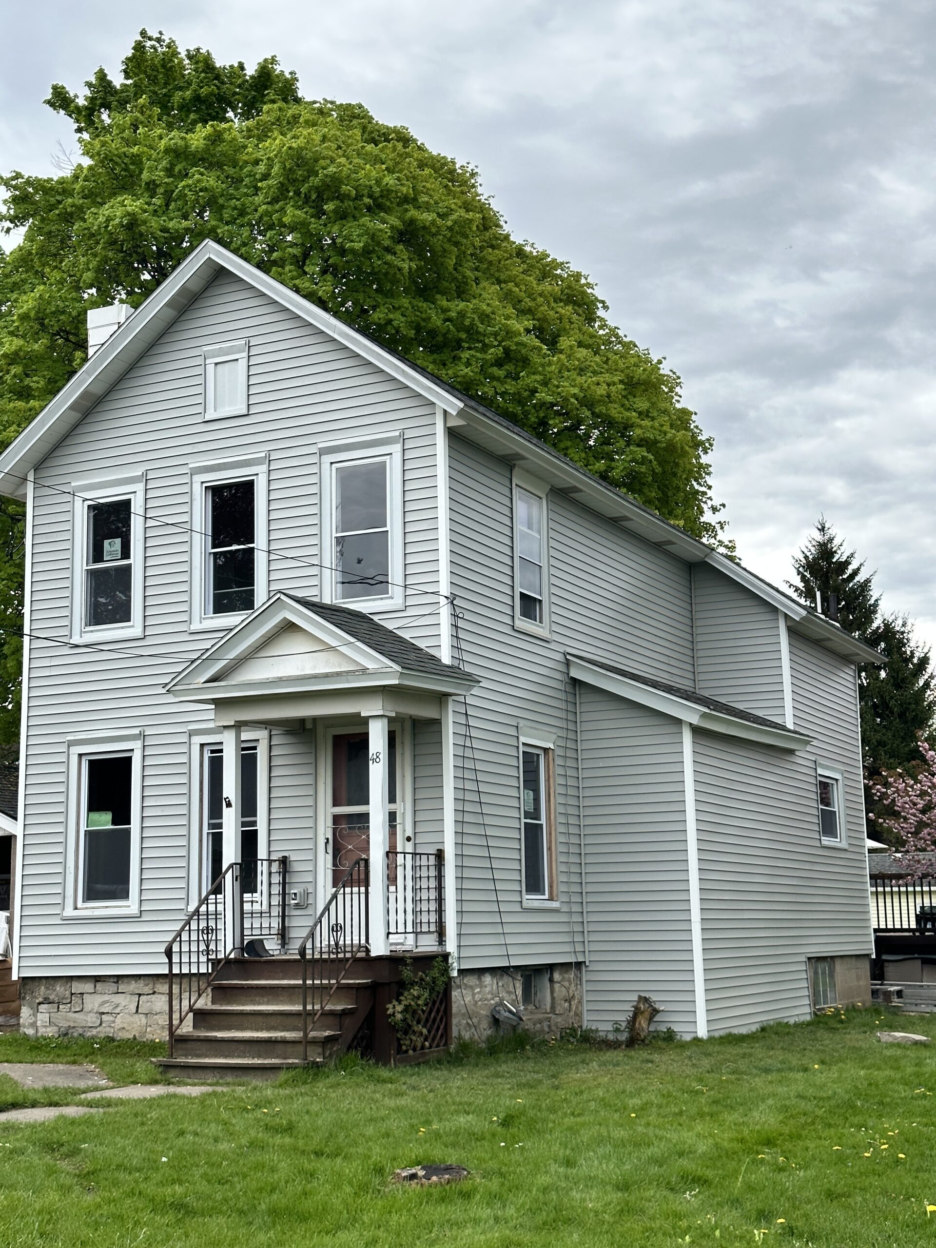 Beautifully completed two-story premium vinyl siding installation on a home in Auburn, NY by WeBuild CNY