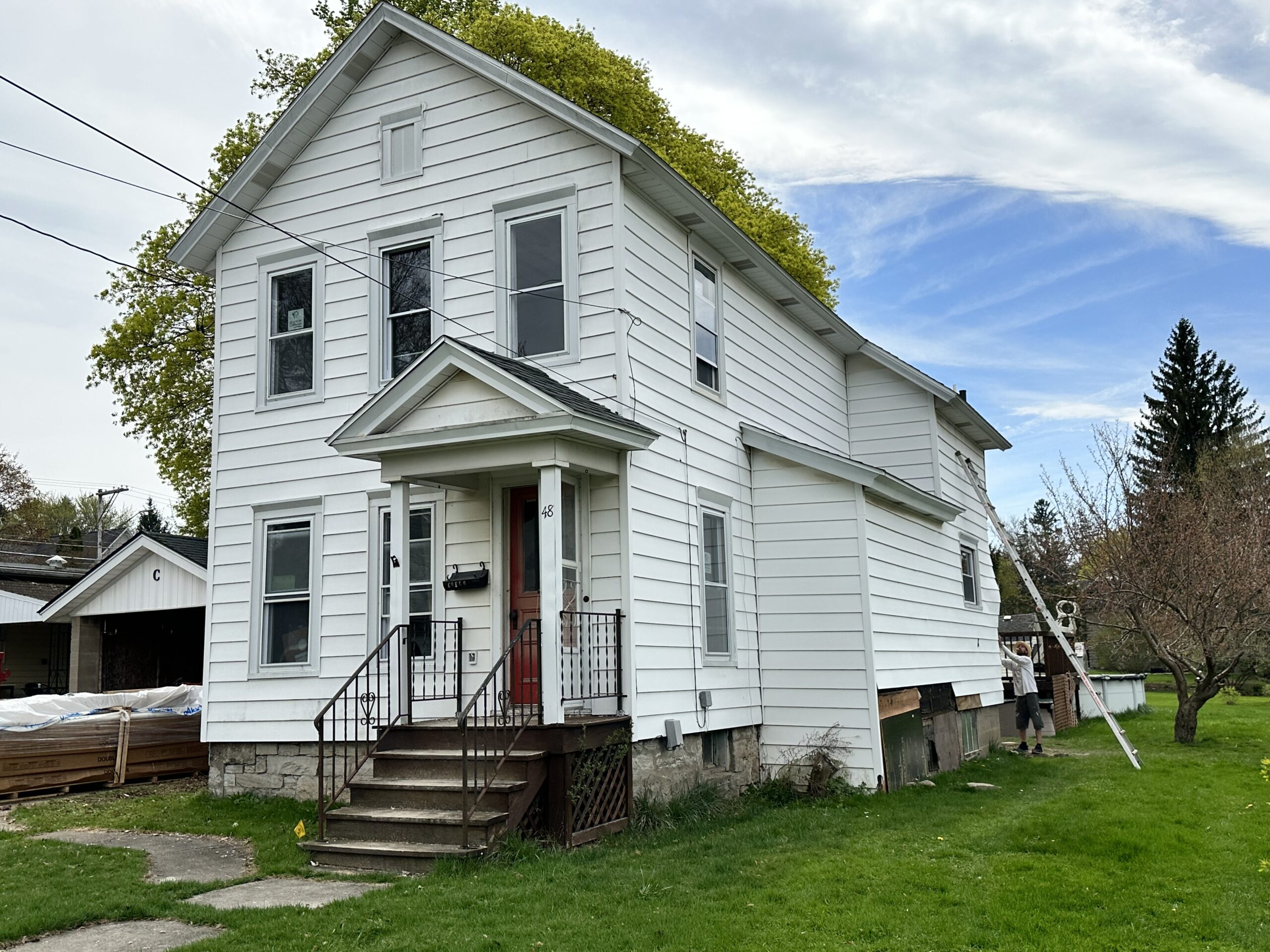 Original exterior condition of the Auburn NY residential property prior to siding replacement