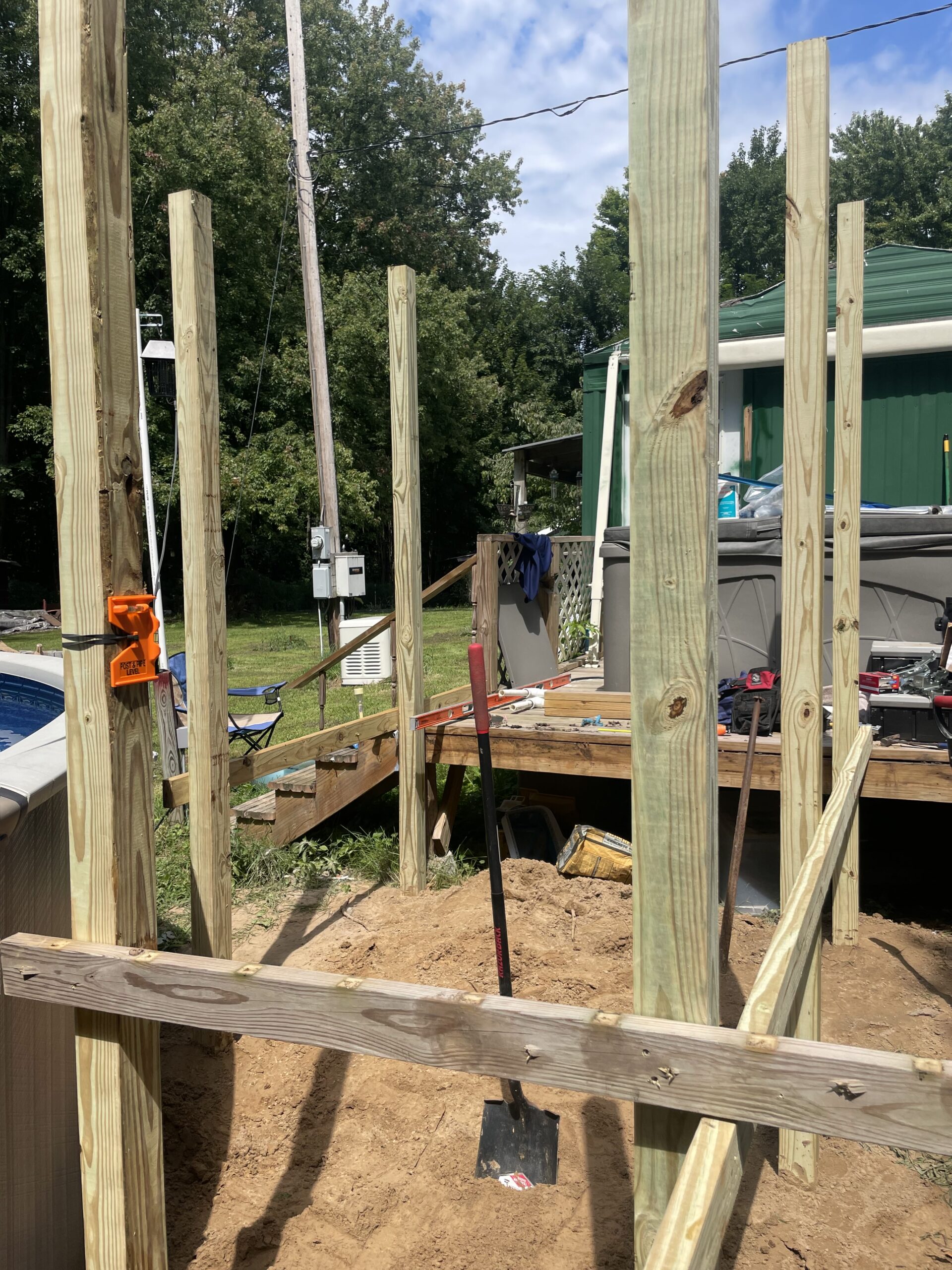 Structural framing and support post installation for a new above-ground pool deck in Auburn NY