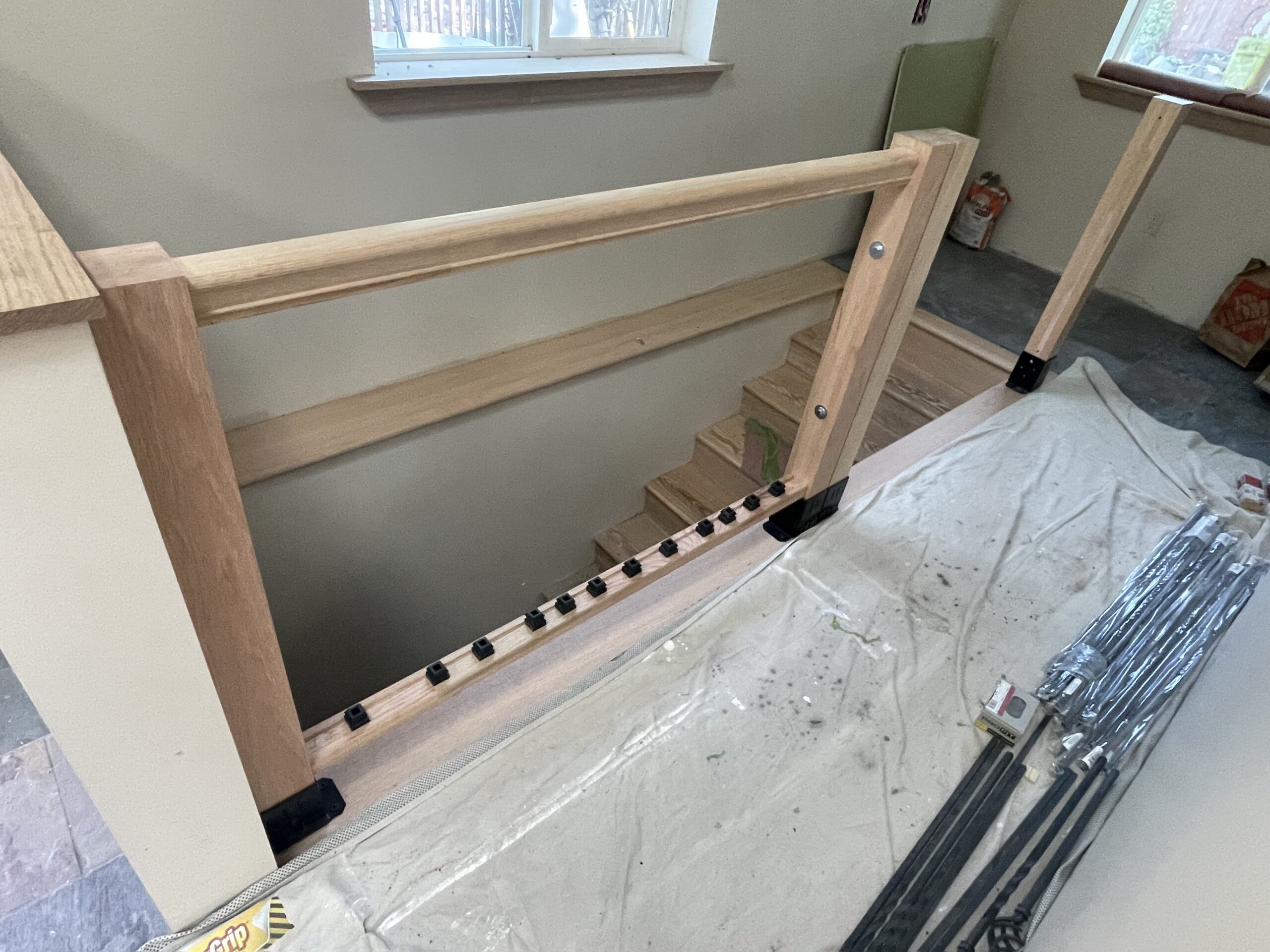 Fitting wooden balusters and interior trim during a staircase renovation