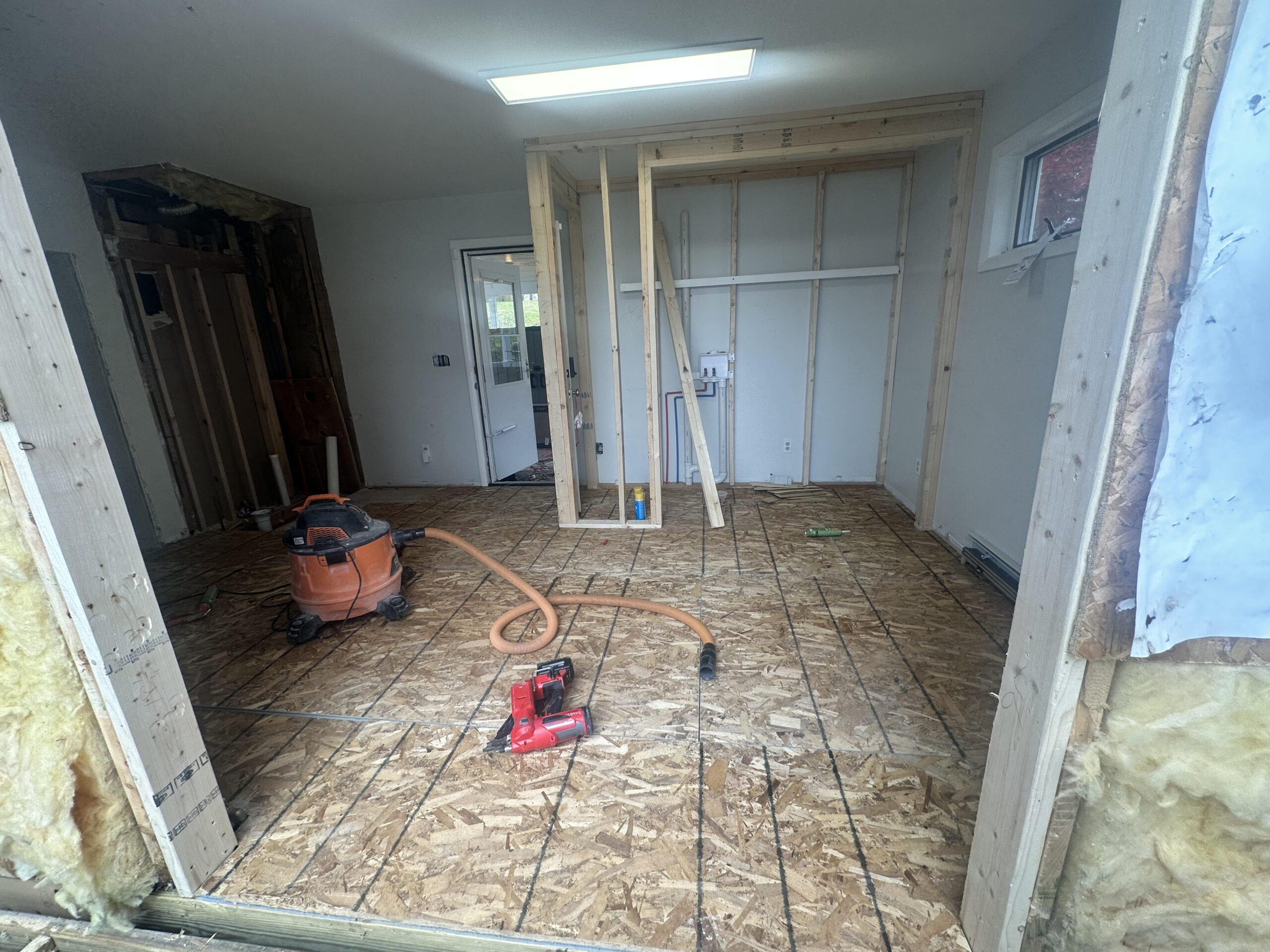 Bathroom tiling and waterproofing progress in the Cayuga Lake rental home