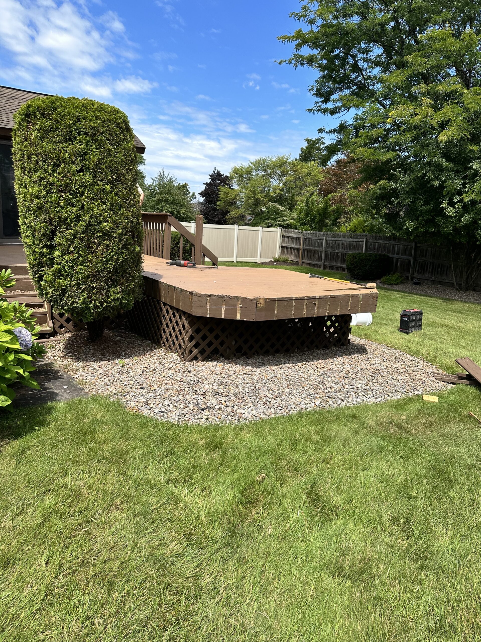 Before photo of an aging, weathered wooden deck prior to a complete composite remodel