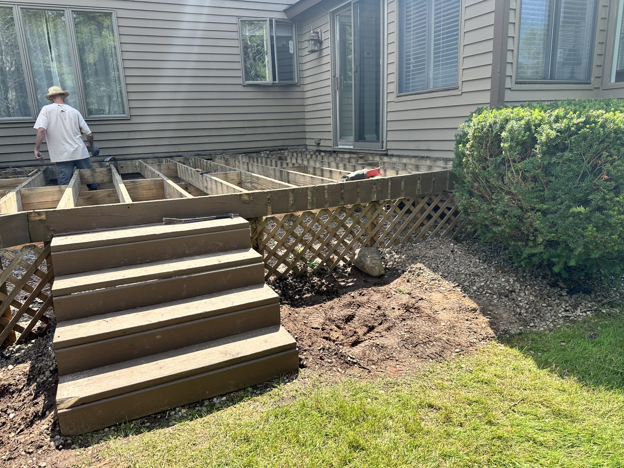 Backyard view of the old wooden deck needing an upgrade to low-maintenance composite materials