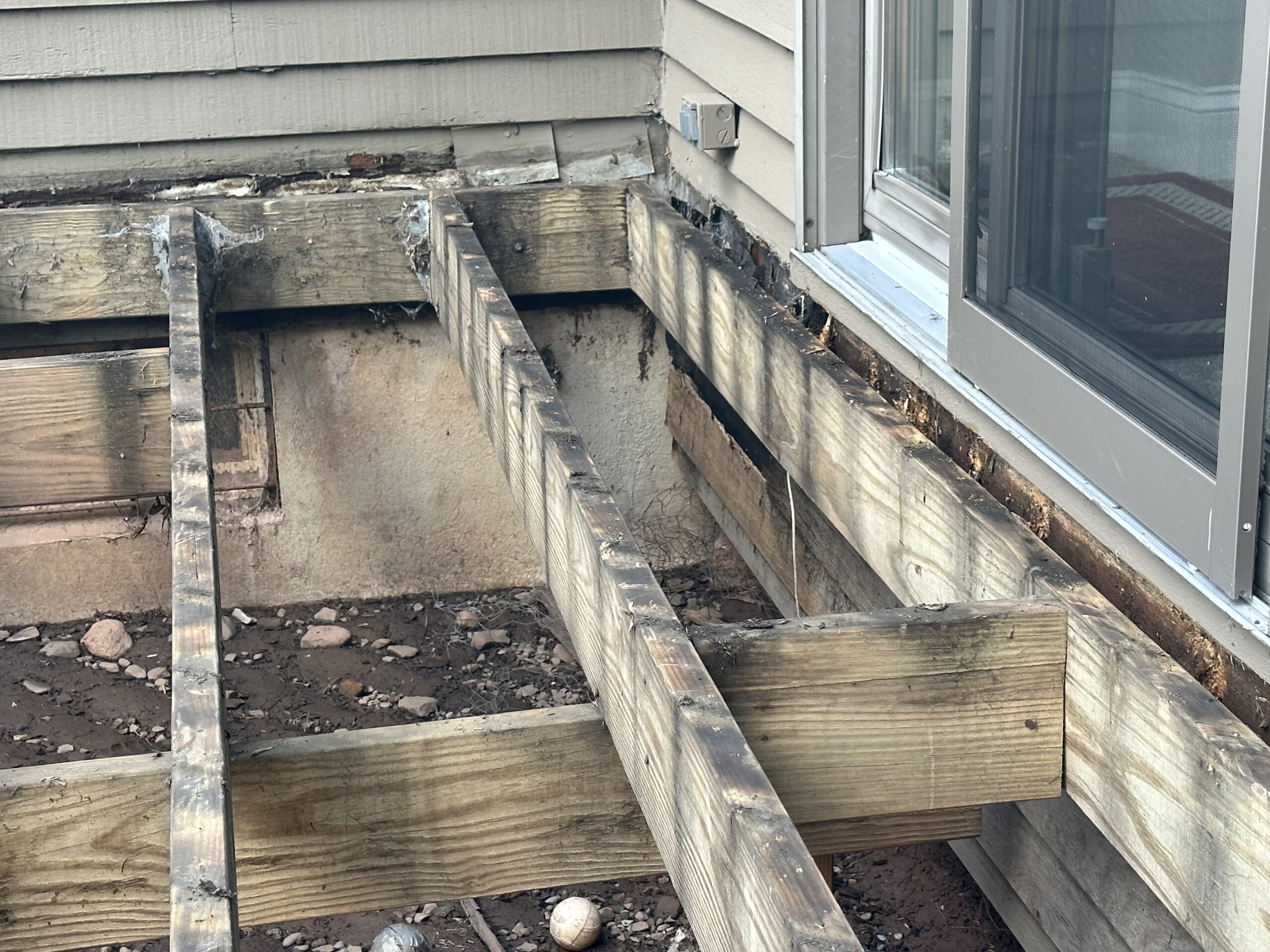 Pre-construction exterior condition of the Liverpool New York home's outdoor living space