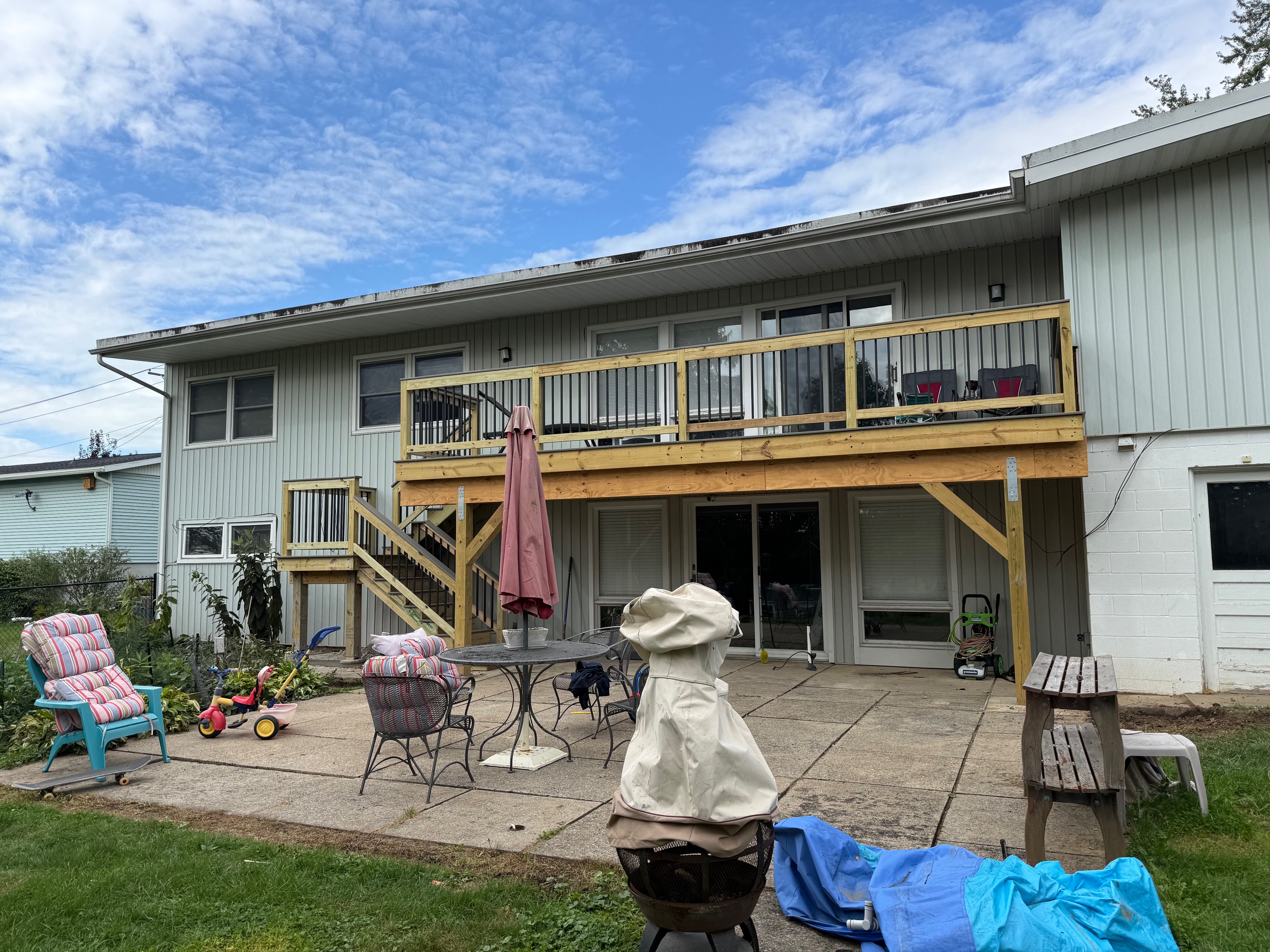Beautiful countryside deck featuring black metal balusters and unobstructed walkout basement views