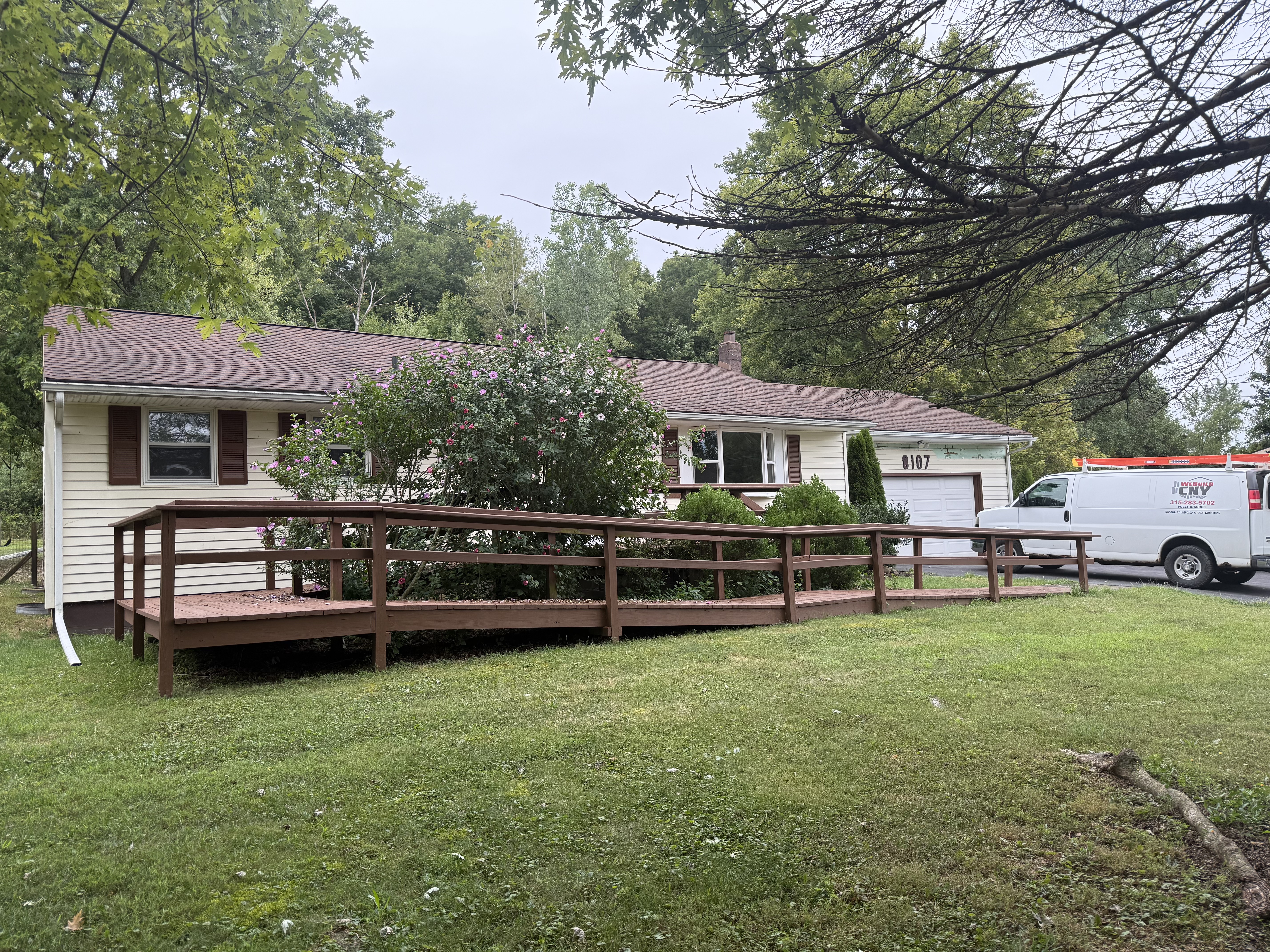 Before photo of failing 1990s seamless siding on a Port Byron home