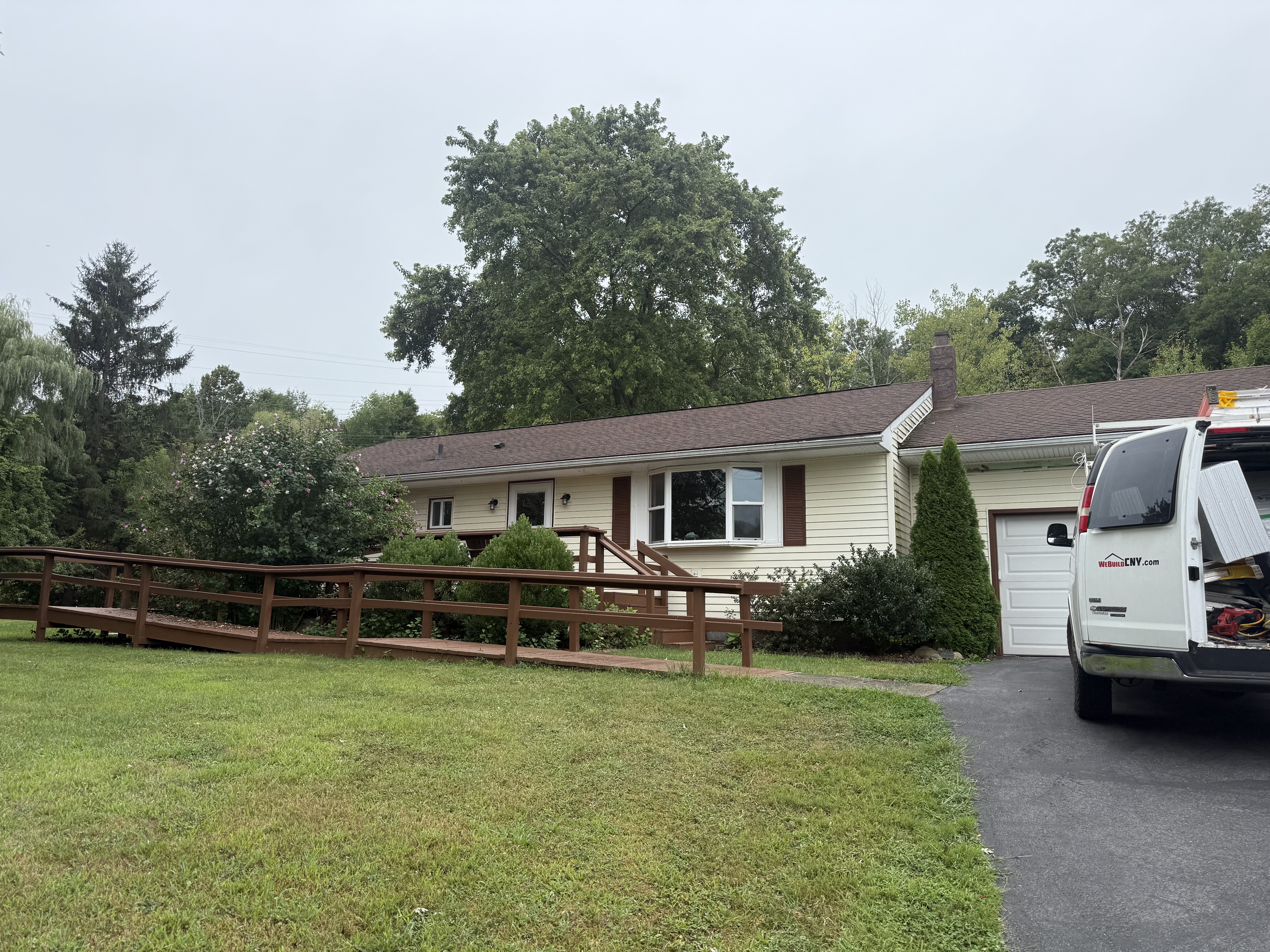 Original drafty windows and outdated exterior prior to WeBuild CNY remodeling