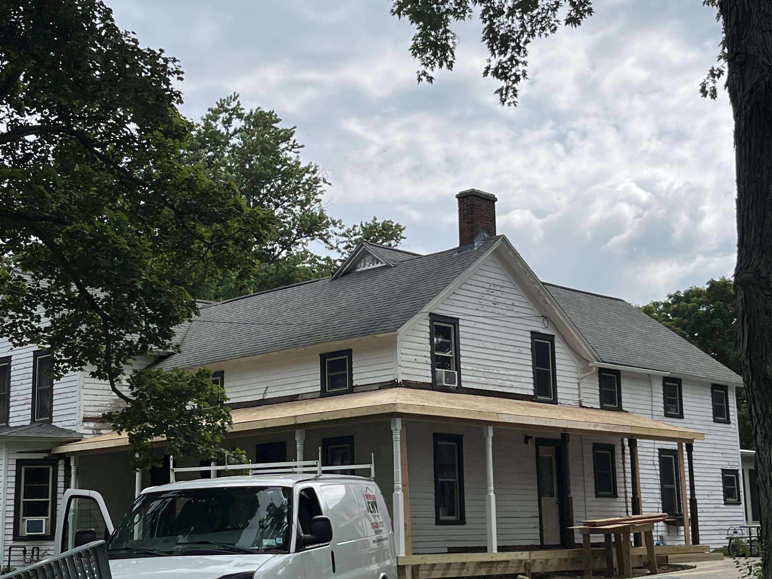 Structural framing and floor joist repair during a farmhouse porch restoration in Cayuga County