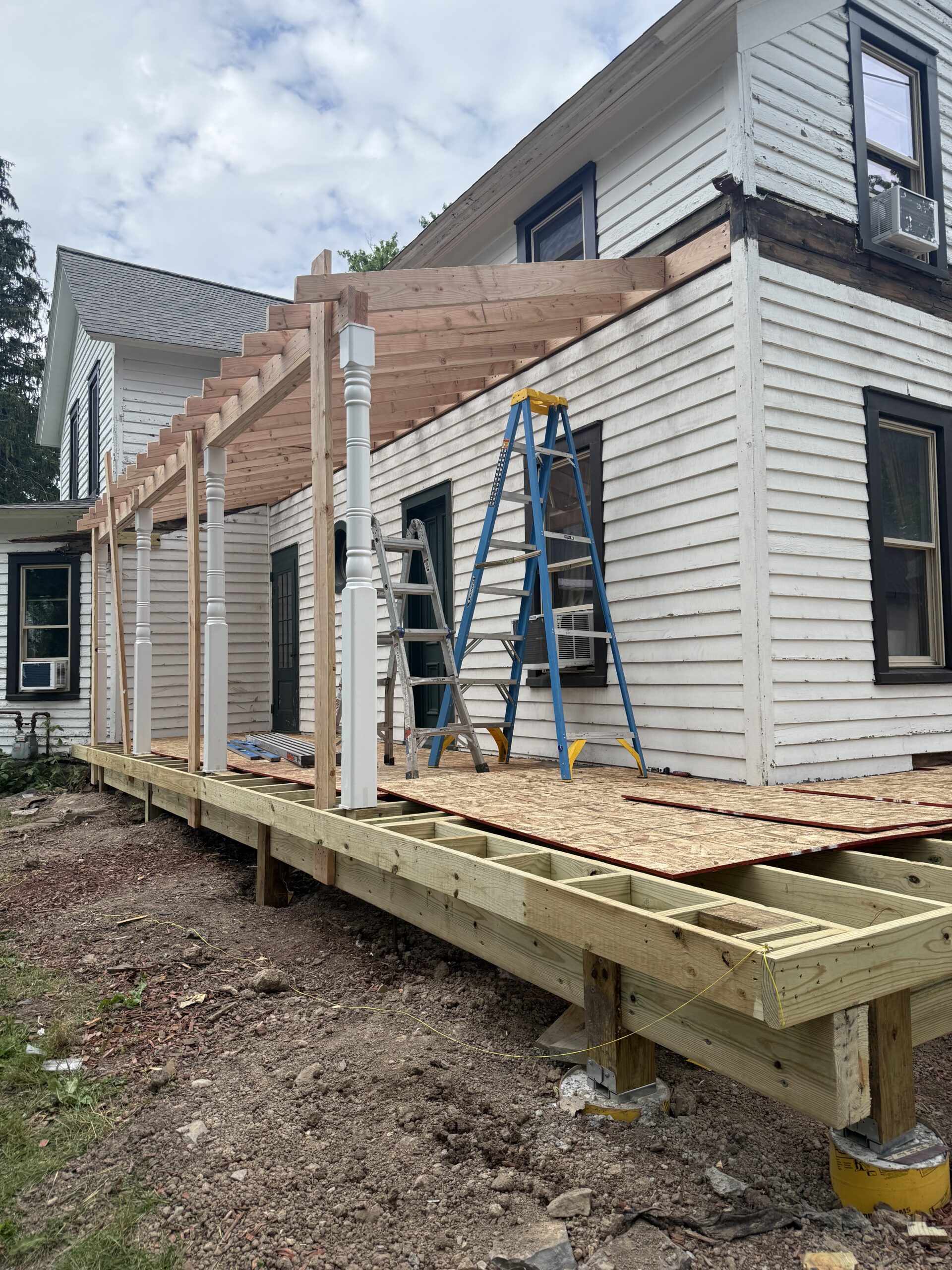 Custom porch railing installation progress on a 100-year-old historic home in Fleming New York
