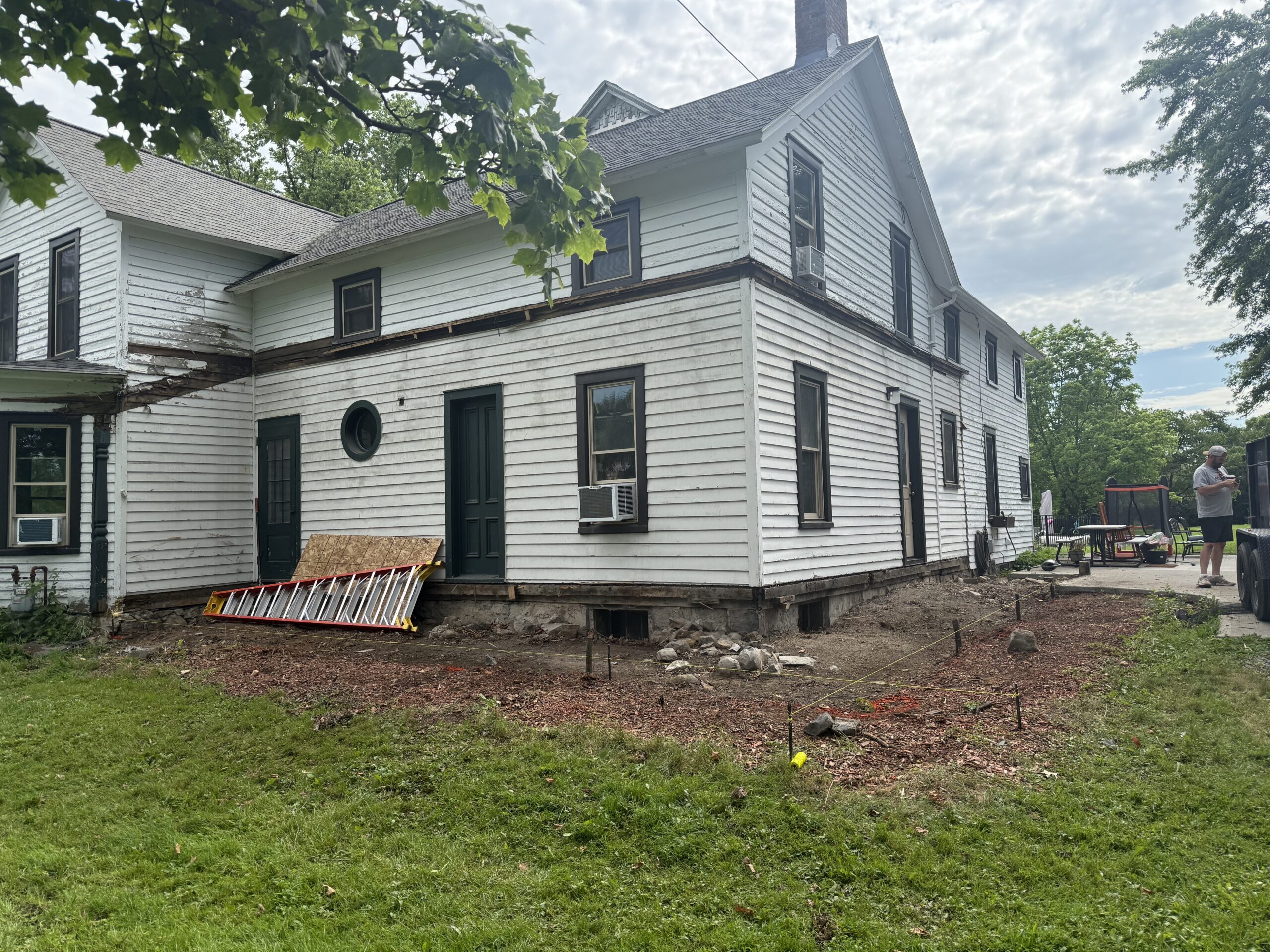 Detail work on structural posts and mahogany cocktail rails during exterior porch remodeling