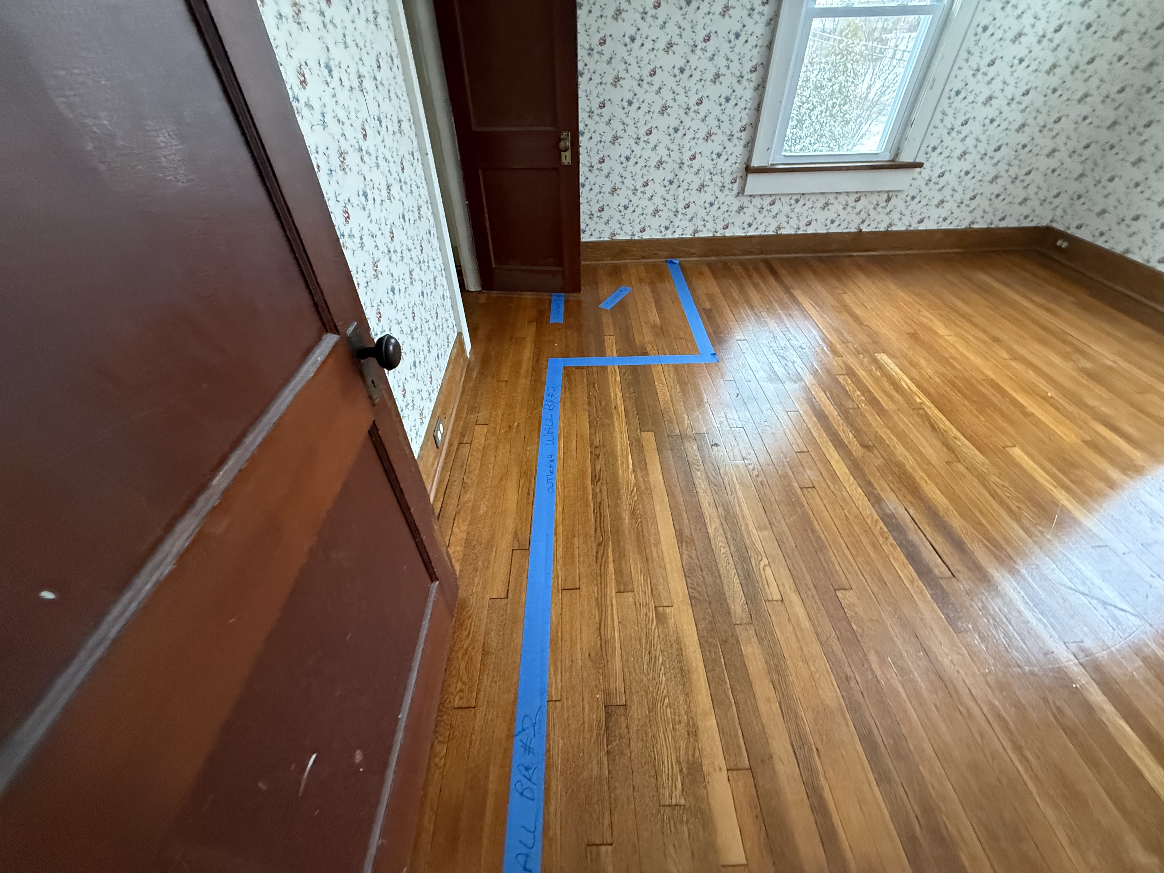 Small, closed-off bedroom spaces before structural wall removal