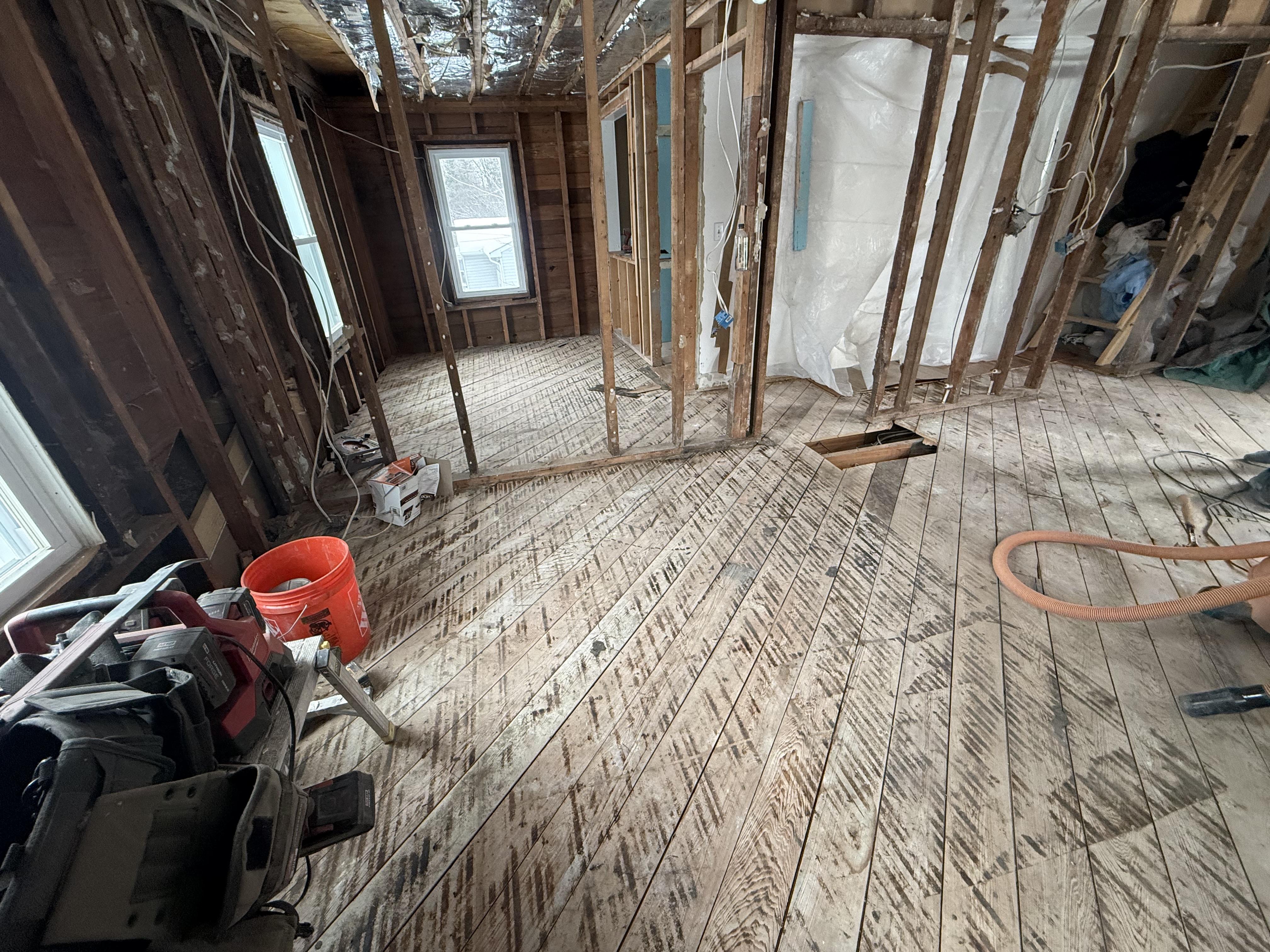 Installing drywall and structural supports for the new open floor plan