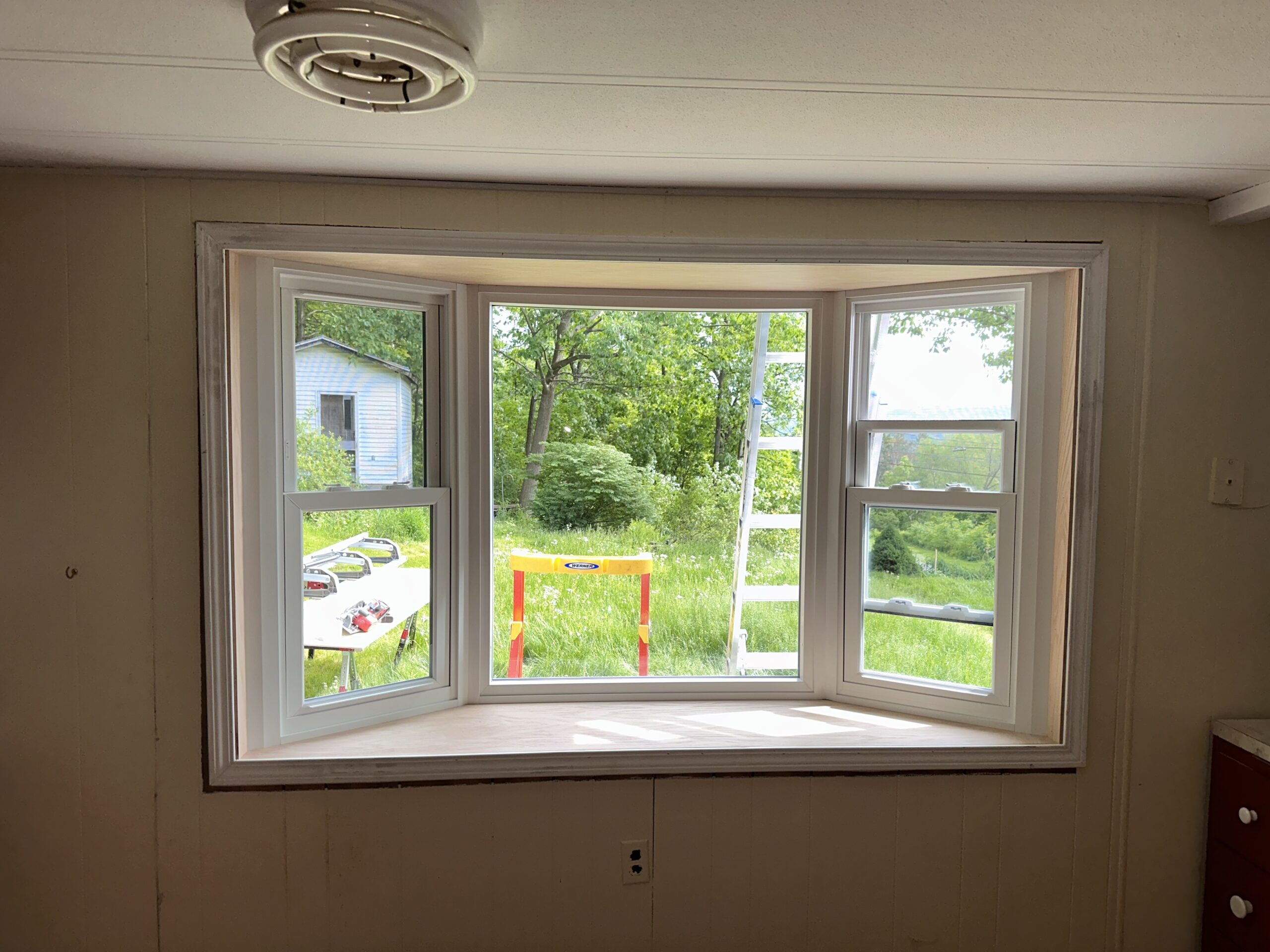 Close-up of newly installed double-hung vinyl windows by WeBuild CNY contractors