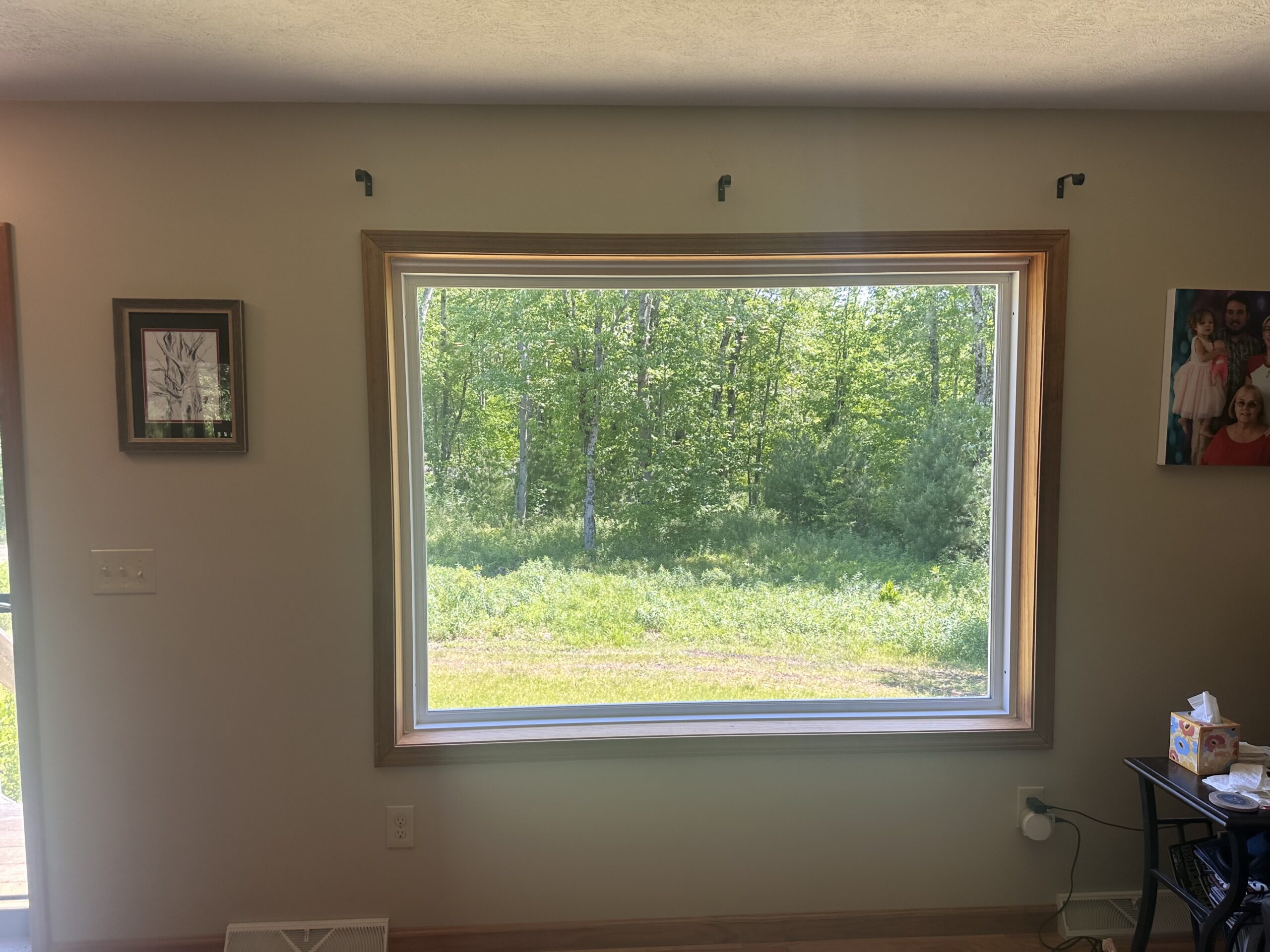 Pre-installation view of a Cayuga County home exterior before modern vinyl window retrofitting