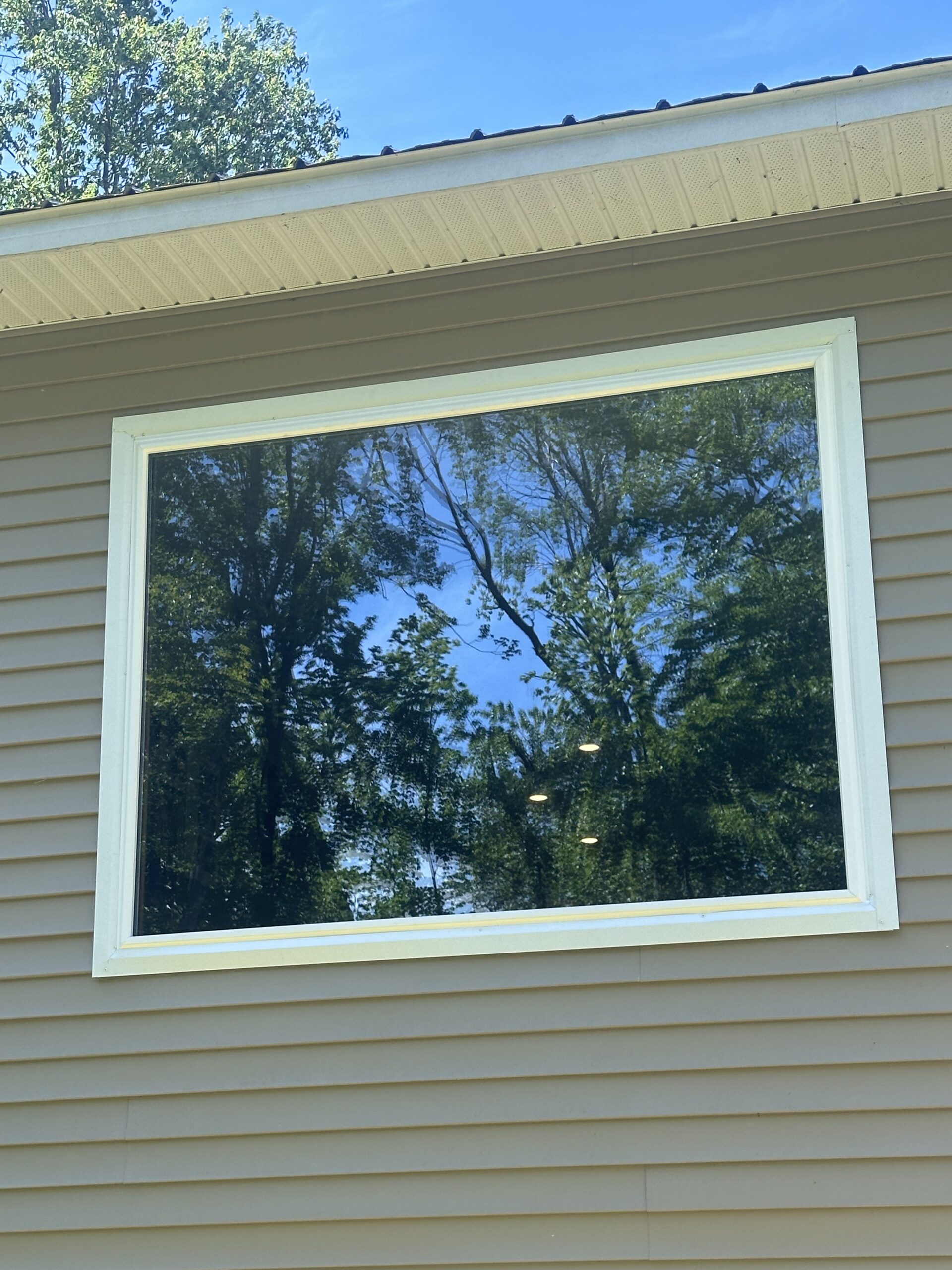 Completed exterior transformation featuring low-maintenance vinyl window replacements